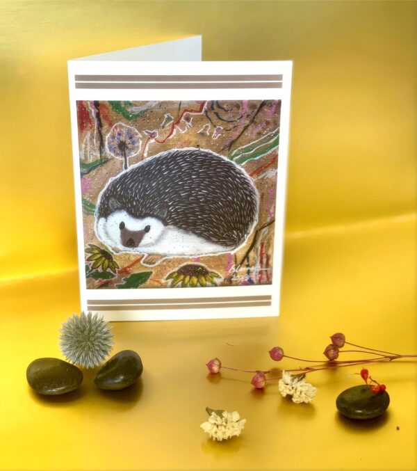 A card with an image of a painted hedgehog.